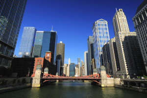 Chicago river in downtown with towering skyscrapers and a bridge