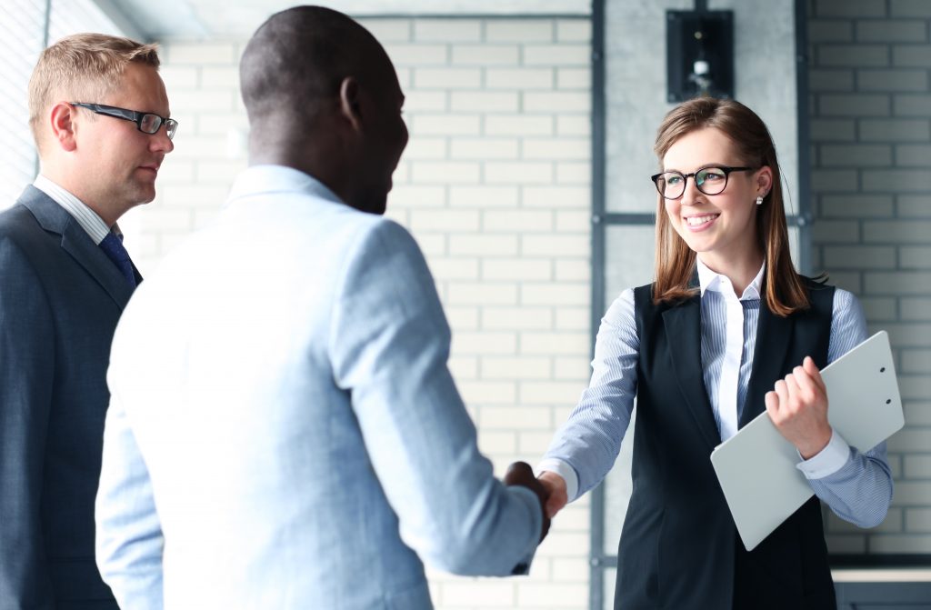 Business handshake. Business people shaking hands, finishing up a meeting