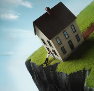 Man leaning against house near cliff