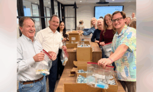 Harry Norman Cares volunteers pack care kits.