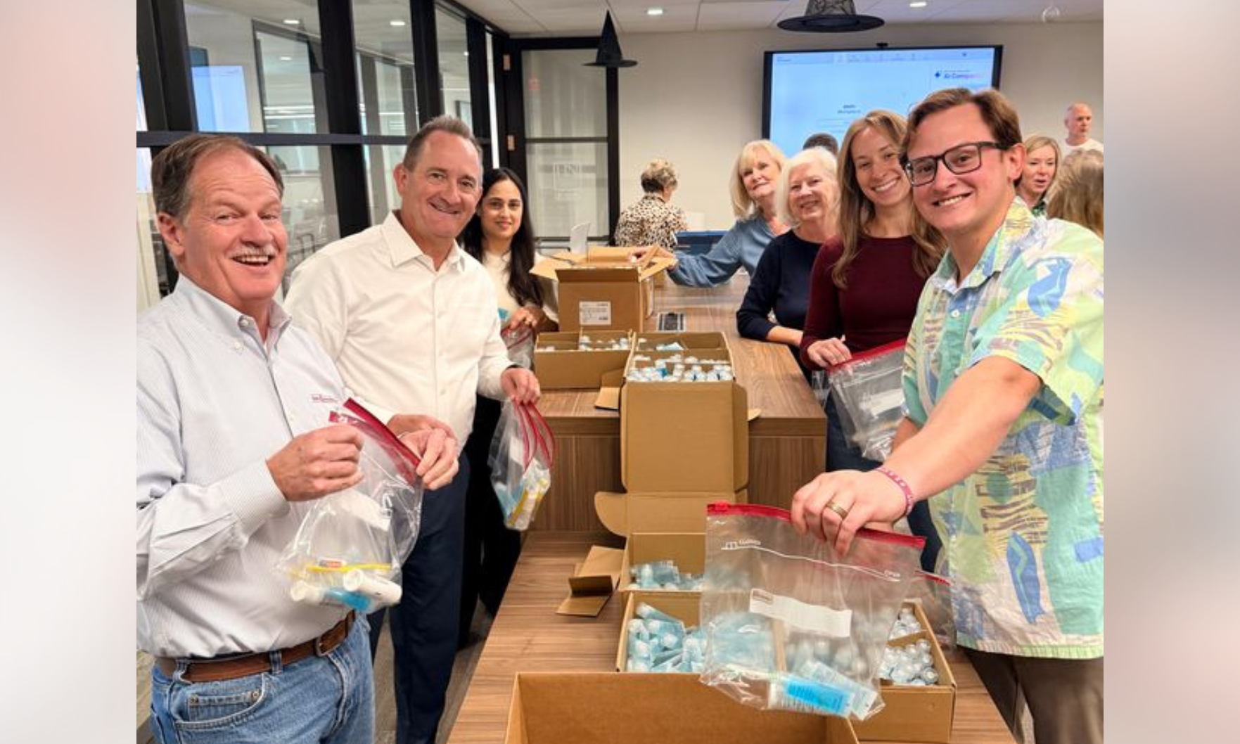 Harry Norman Cares volunteers pack care kits.