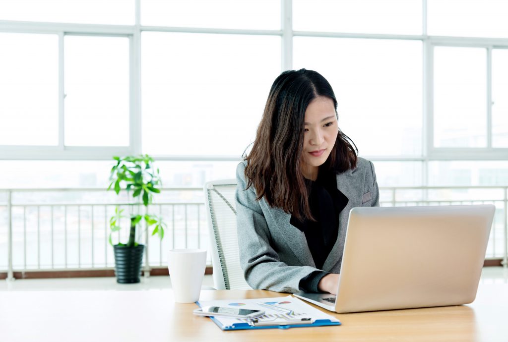 Young businesswoman working in the office with laptop.